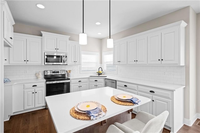 28225 W 162nd Ter, Gardner, KS 66030 - kitchen featuring appliances with stainless steel finishes, a kitchen breakfast bar, white cabinets, and recessed lighting