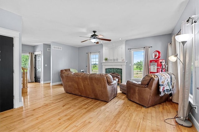 1148 N 1st Rd, Baldwin City, KS 66006 - living room with light wood finished floors, a ceiling fan, plenty of natural light, and a premium fireplace