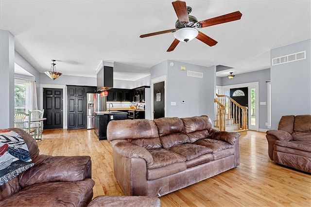 1148 N 1st Rd, Baldwin City, KS 66006 - living area featuring light wood-type flooring, stairway, and a ceiling fan