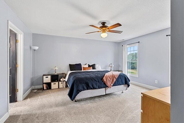 1148 N 1st Rd, Baldwin City, KS 66006 - bedroom featuring light colored carpet, a ceiling fan, and a textured ceiling