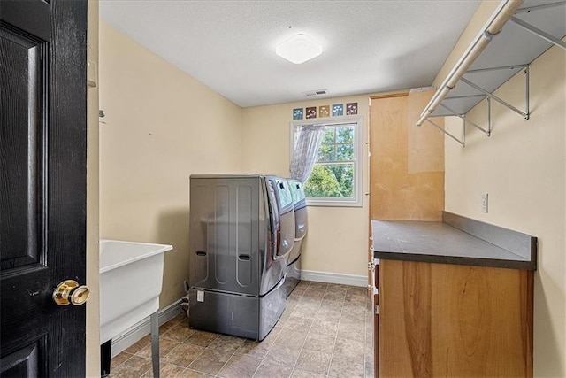 1148 N 1st Rd, Baldwin City, KS 66006 - laundry room with washer and clothes dryer, a textured ceiling, and light tile patterned flooring