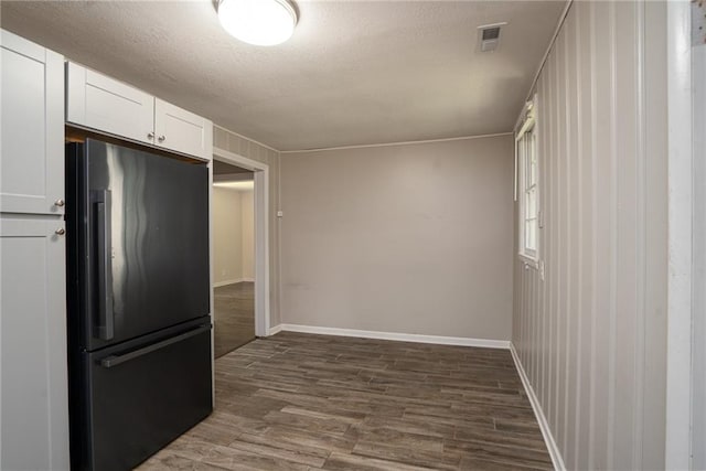 914 Jersey St, Baldwin City, KS 66006 - kitchen with freestanding refrigerator, dark wood-type flooring, white cabinets, and a textured ceiling