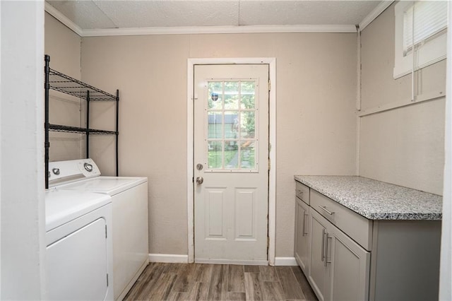 914 Jersey St, Baldwin City, KS 66006 - laundry room featuring light wood-style flooring, washing machine and clothes dryer, and ornamental molding