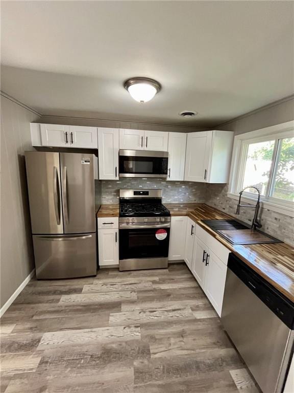 1629 E Oak St, Fort Scott, KS 66701 - kitchen featuring stainless steel appliances, butcher block countertops, and white cabinets