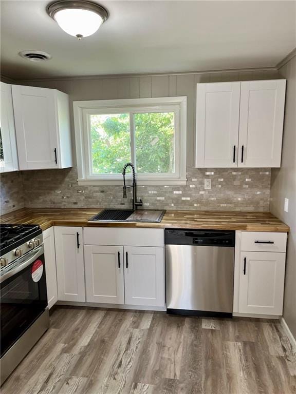 1629 E Oak St, Fort Scott, KS 66701 - kitchen featuring appliances with stainless steel finishes, wooden counters, and decorative backsplash