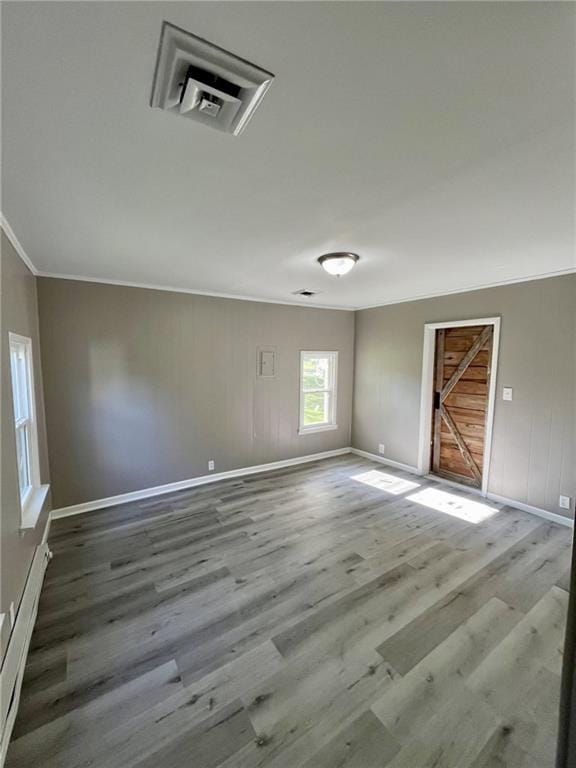 1629 E Oak St, Fort Scott, KS 66701 - empty room with wood finished floors, ornamental molding, and a baseboard radiator