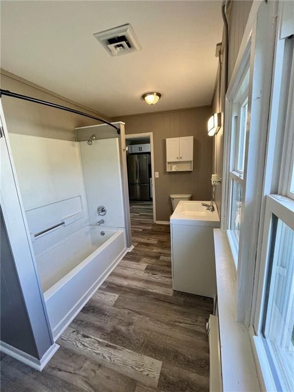 1629 E Oak St, Fort Scott, KS 66701 - full bathroom with vanity, wood finished floors, and shower / bathtub combination