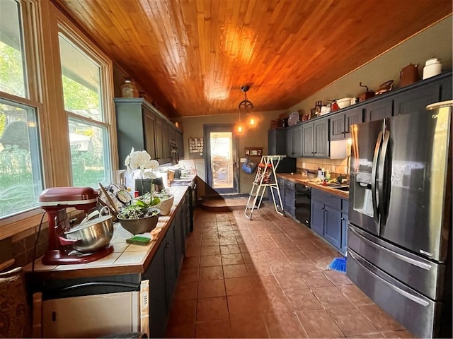 22 U Lake Shore Dr, Lake Lotawana, MO 64086 - kitchen featuring stainless steel fridge with ice dispenser, wood ceiling, tile countertops, dark tile patterned floors, and plenty of natural light