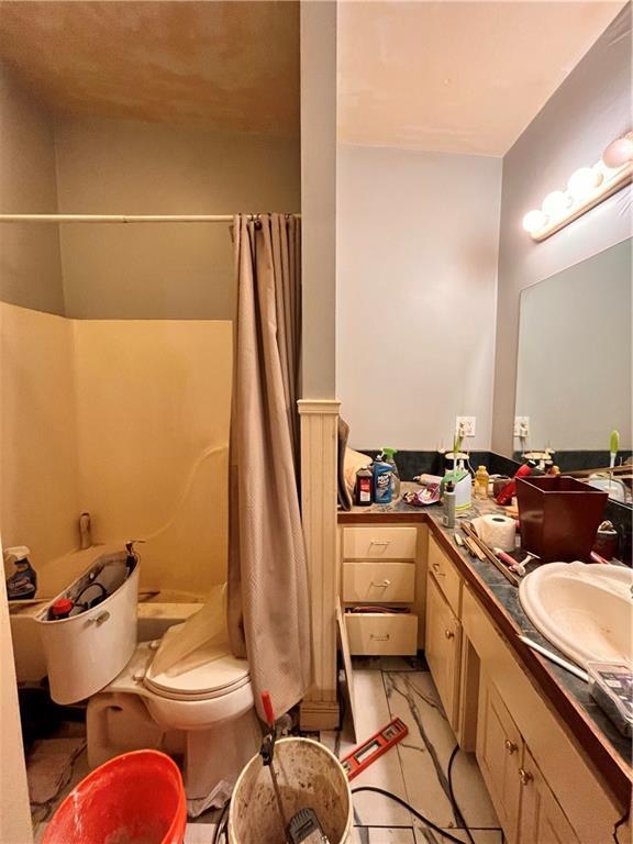 22 U Lake Shore Dr, Lake Lotawana, MO 64086 - bathroom with vanity and curtained shower