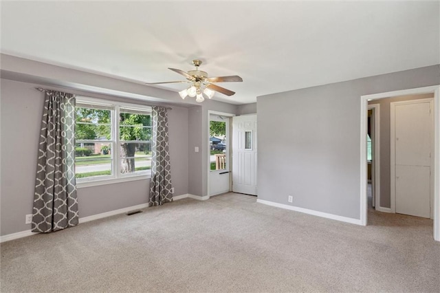 609 W Beech St, Independence, KS 67301 - empty room featuring a ceiling fan and light colored carpet