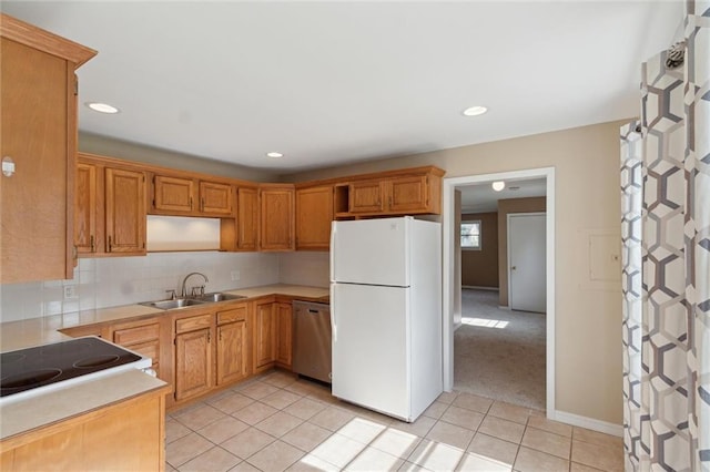 609 W Beech St, Independence, KS 67301 - kitchen with freestanding refrigerator, stainless steel dishwasher, light tile patterned floors, tasteful backsplash, and light countertops