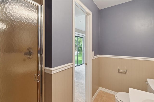 609 W Beech St, Independence, KS 67301 - full bath featuring a stall shower, wainscoting, tile patterned flooring, and vanity