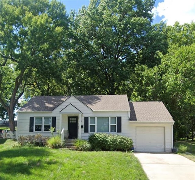 6212 Hadley St, Mission, KS 66202 - view of front of home featuring an attached garage, driveway, and a shingled roof