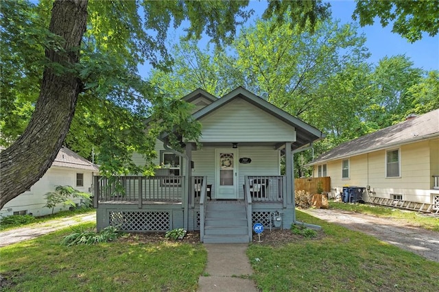 707 W 75th Ter, Kansas City, MO 64114 - view of front facade with a porch and a front yard