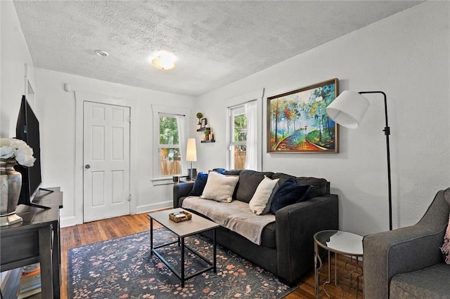 707 W 75th Ter, Kansas City, MO 64114 - living area featuring wood finished floors and a textured ceiling