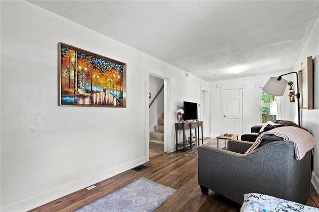 707 W 75th Ter, Kansas City, MO 64114 - living room featuring dark wood finished floors and stairway