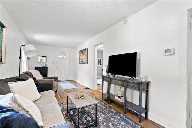 707 W 75th Ter, Kansas City, MO 64114 - living room featuring wood finished floors and baseboards