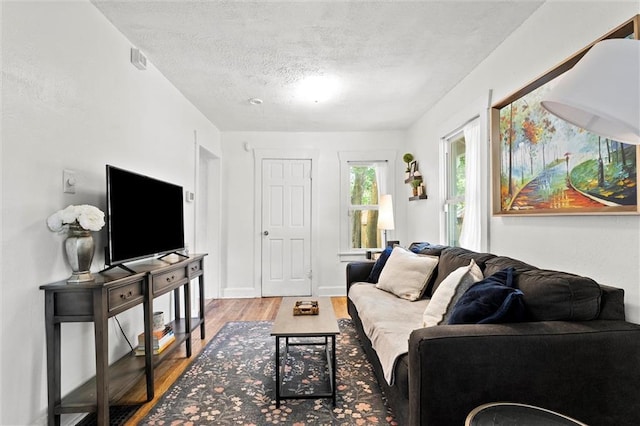 707 W 75th Ter, Kansas City, MO 64114 - living room featuring a textured ceiling and wood finished floors