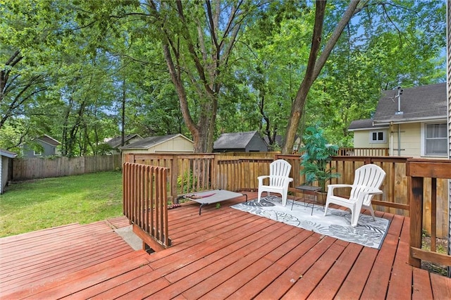 707 W 75th Ter, Kansas City, MO 64114 - wooden deck with a fenced backyard, a storage shed, and view of wooded area