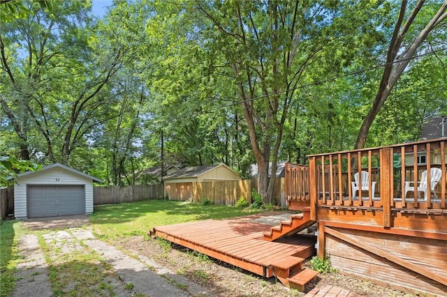 707 W 75th Ter, Kansas City, MO 64114 - fenced backyard with an outdoor structure, a deck, driveway, and a detached garage