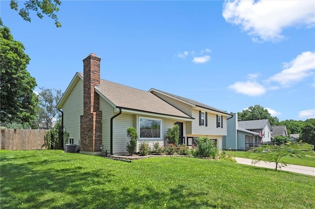 1108 W Pleasant Dr, Raymore, MO 64083 - tri-level home featuring a chimney