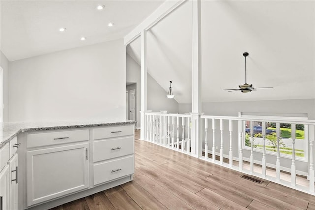 1108 W Pleasant Dr, Raymore, MO 64083 - corridor featuring vaulted ceiling, light wood-type flooring, and recessed lighting