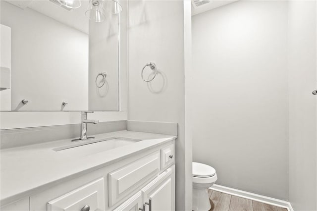 1108 W Pleasant Dr, Raymore, MO 64083 - bathroom with vanity and wood finished floors