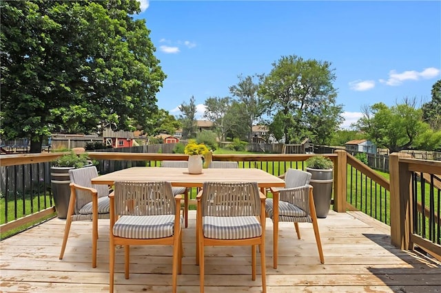 1108 W Pleasant Dr, Raymore, MO 64083 - wooden deck with a fenced backyard and outdoor dining area