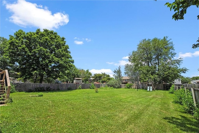 1108 W Pleasant Dr, Raymore, MO 64083 - fenced backyard featuring stairway