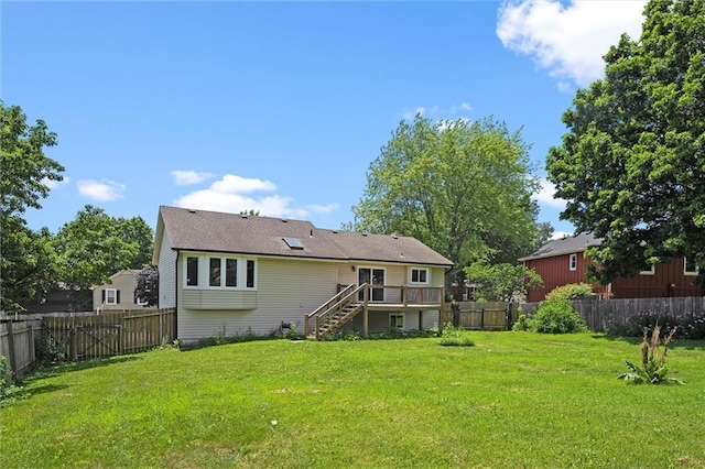 1108 W Pleasant Dr, Raymore, MO 64083 - back of property with stairs, a deck, and a fenced backyard