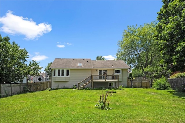 1108 W Pleasant Dr, Raymore, MO 64083 - back of house with stairs, a fenced backyard, and a deck