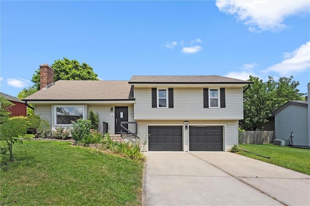 1108 W Pleasant Dr, Raymore, MO 64083 - tri-level home with driveway and a garage