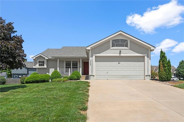 1002 W Howard Pl, Louisburg, KS 66053 - single story home with a porch, a front lawn, stucco siding, an attached garage, and driveway
