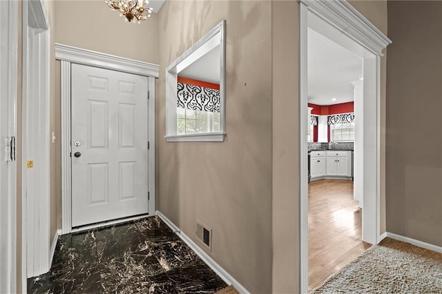 1002 W Howard Pl, Louisburg, KS 66053 - foyer with a chandelier and marble finish flooring