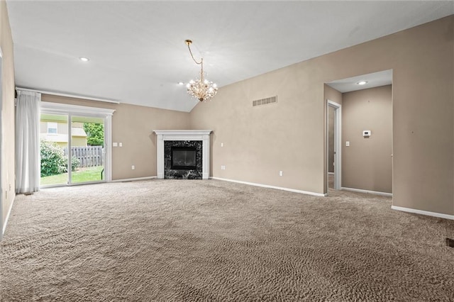 1002 W Howard Pl, Louisburg, KS 66053 - unfurnished living room featuring carpet, a fireplace, vaulted ceiling, a chandelier, and recessed lighting