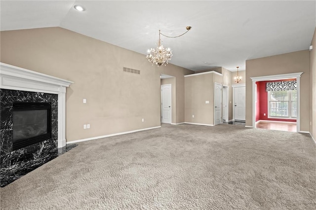 1002 W Howard Pl, Louisburg, KS 66053 - unfurnished living room featuring a chandelier, a premium fireplace, carpet flooring, and vaulted ceiling