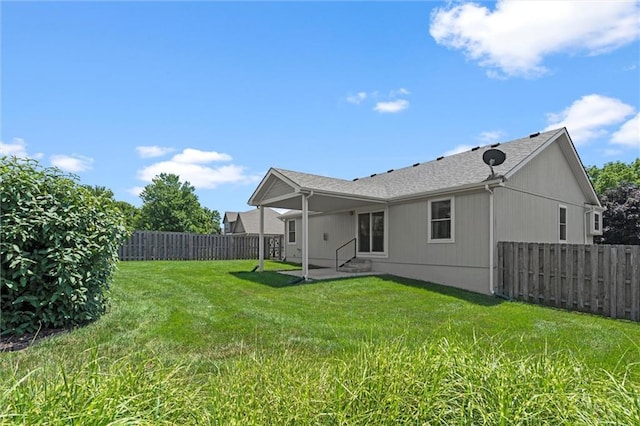 1002 W Howard Pl, Louisburg, KS 66053 - back of property with entry steps, a fenced backyard, and a patio area