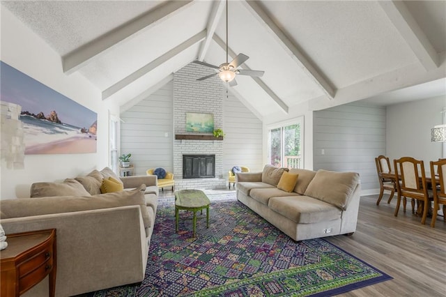 6613 E 123rd Ter, Grandview, MO 64030 - living room featuring wood finished floors, a ceiling fan, a fireplace, and wood walls