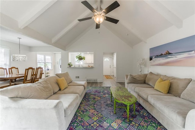 6613 E 123rd Ter, Grandview, MO 64030 - living room featuring beam ceiling, a ceiling fan, light wood finished floors, and high vaulted ceiling