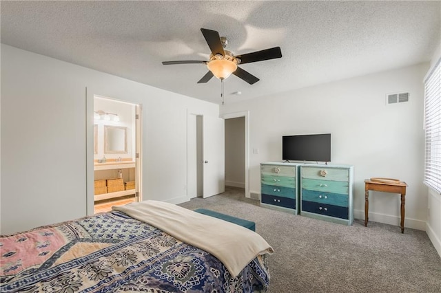 6613 E 123rd Ter, Grandview, MO 64030 - bedroom featuring a textured ceiling, ceiling fan, ensuite bath, and carpet flooring