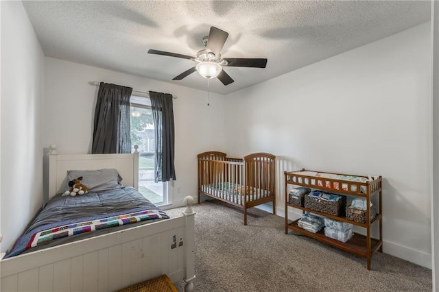 6613 E 123rd Ter, Grandview, MO 64030 - bedroom featuring carpet floors, a textured ceiling, and ceiling fan