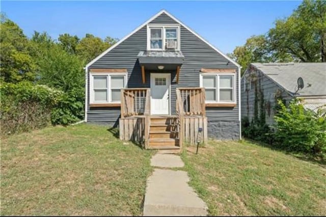3133 Chelsea Ave, Kansas City, MO 64128 - view of front of home featuring a front lawn and a wooden deck