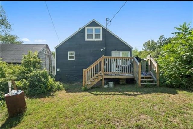 3133 Chelsea Ave, Kansas City, MO 64128 - rear view of property with a lawn, a deck, and stairs