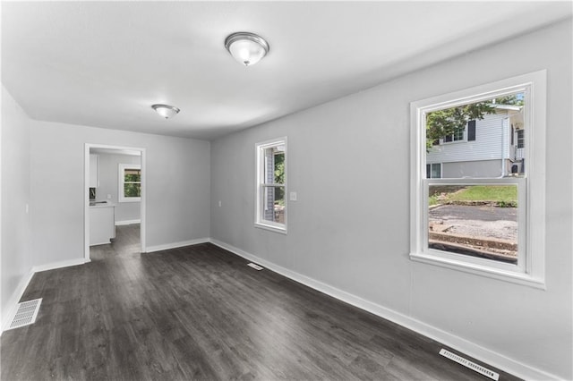 1205 E Parker Ave, Independence, MO 64050 - empty room with dark wood-type flooring and baseboards