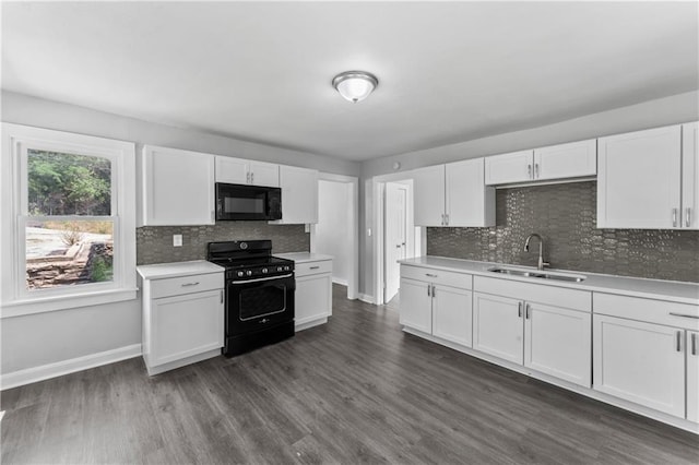 1205 E Parker Ave, Independence, MO 64050 - kitchen featuring black appliances, light countertops, white cabinets, and backsplash