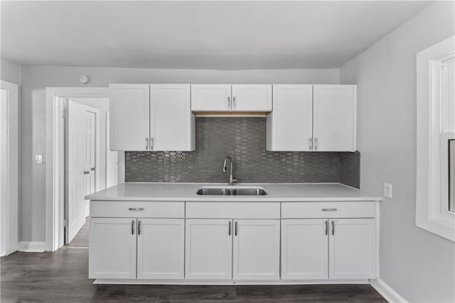 1205 E Parker Ave, Independence, MO 64050 - kitchen with light countertops, white cabinetry, and tasteful backsplash
