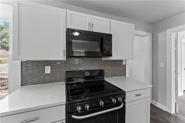 1205 E Parker Ave, Independence, MO 64050 - kitchen with black appliances, light countertops, white cabinetry, and decorative backsplash