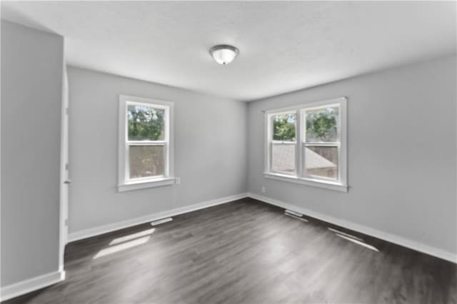 1205 E Parker Ave, Independence, MO 64050 - spare room with healthy amount of natural light and dark wood-style floors