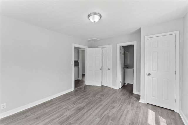 1205 E Parker Ave, Independence, MO 64050 - unfurnished bedroom featuring wood finished floors and baseboards