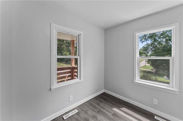 1205 E Parker Ave, Independence, MO 64050 - spare room with baseboards and dark wood-type flooring